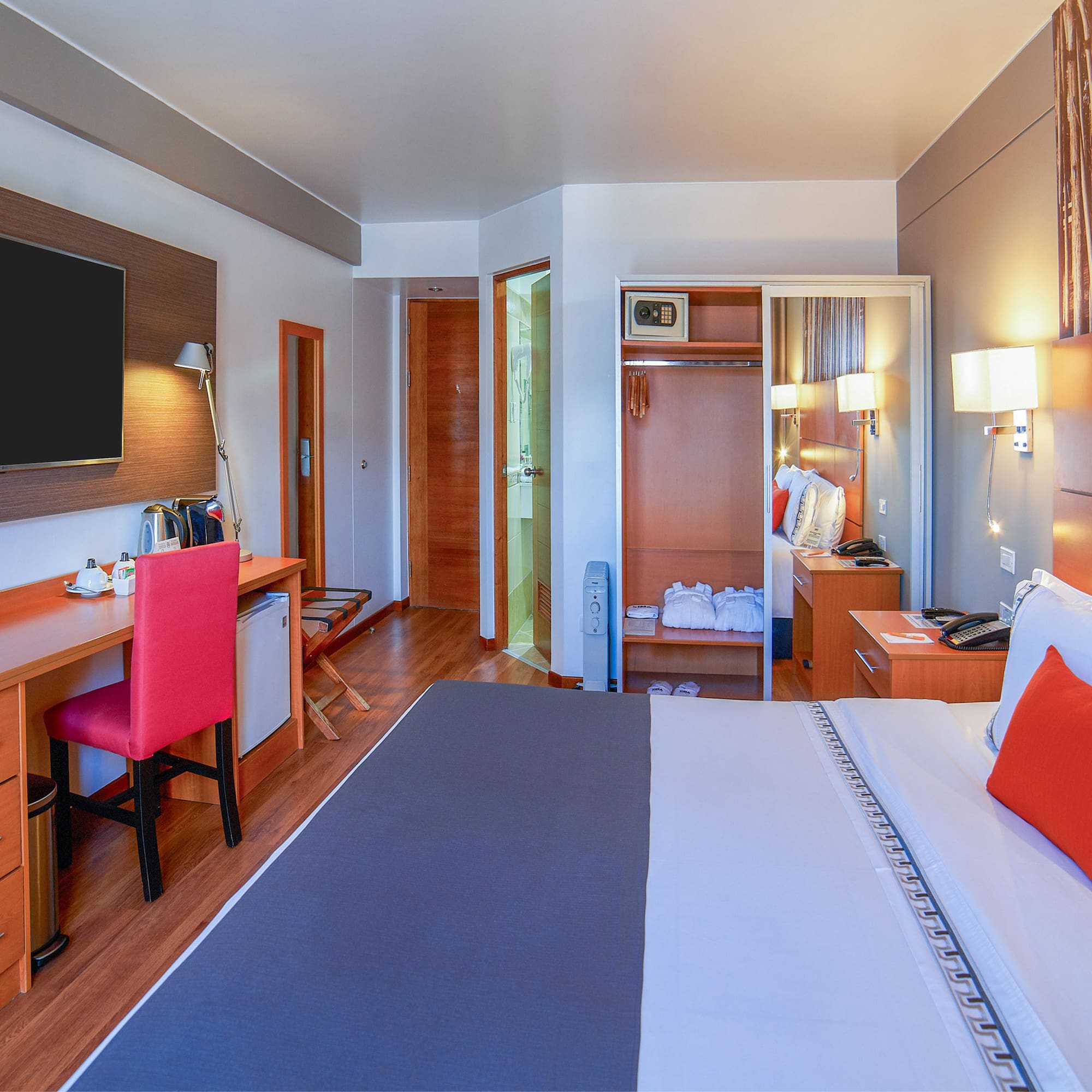 a room with a bed and a tv