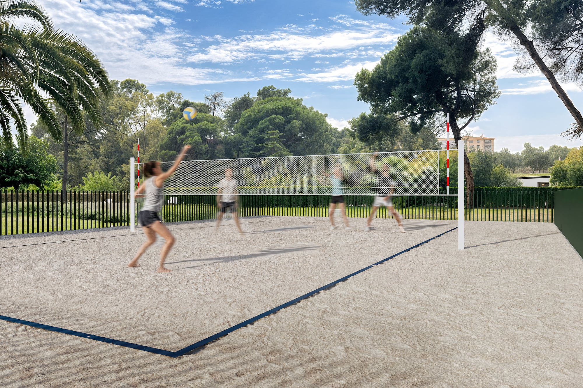 People playing beach volleyball on a sand court under a sunny sky.