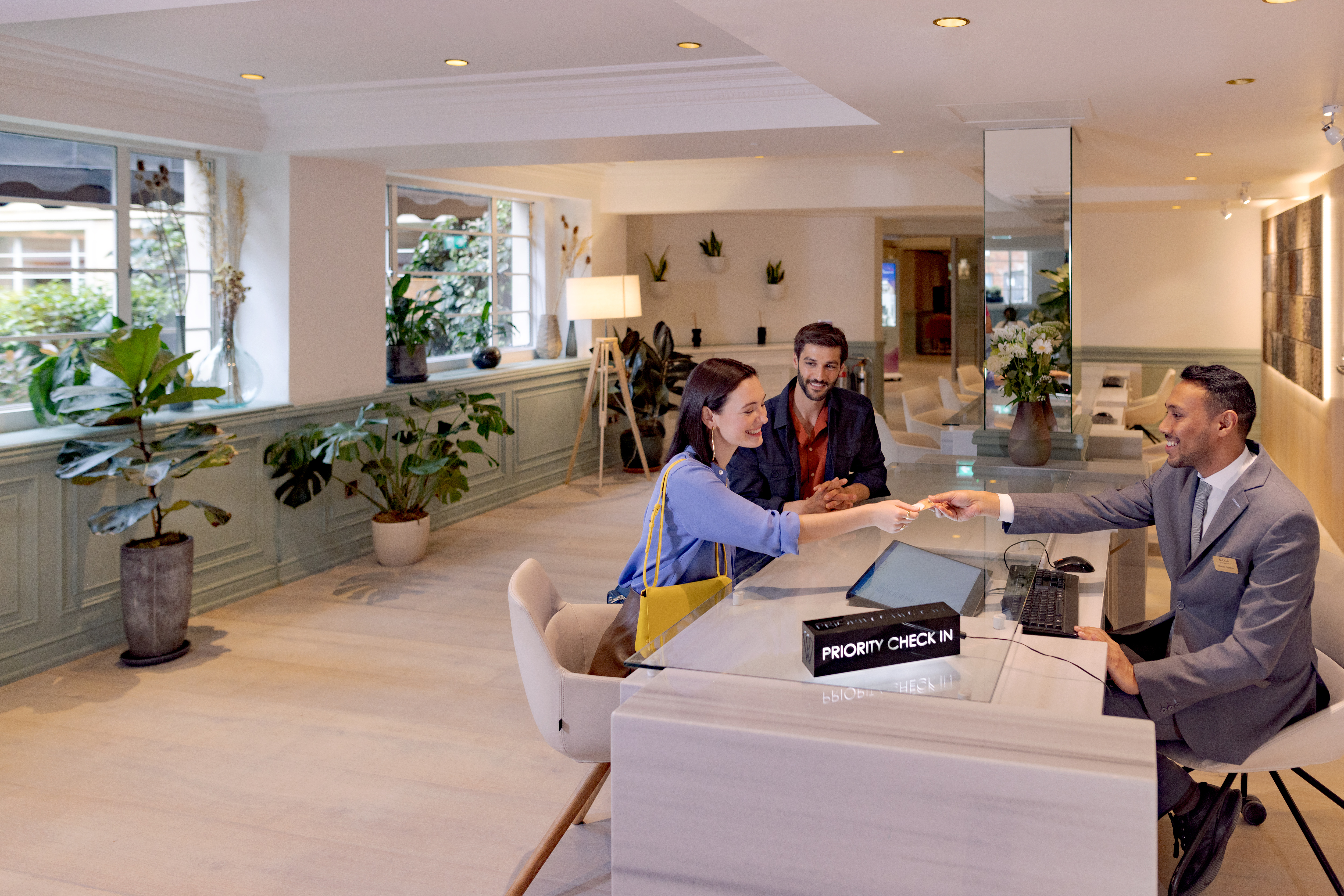 a man handing a woman a check in