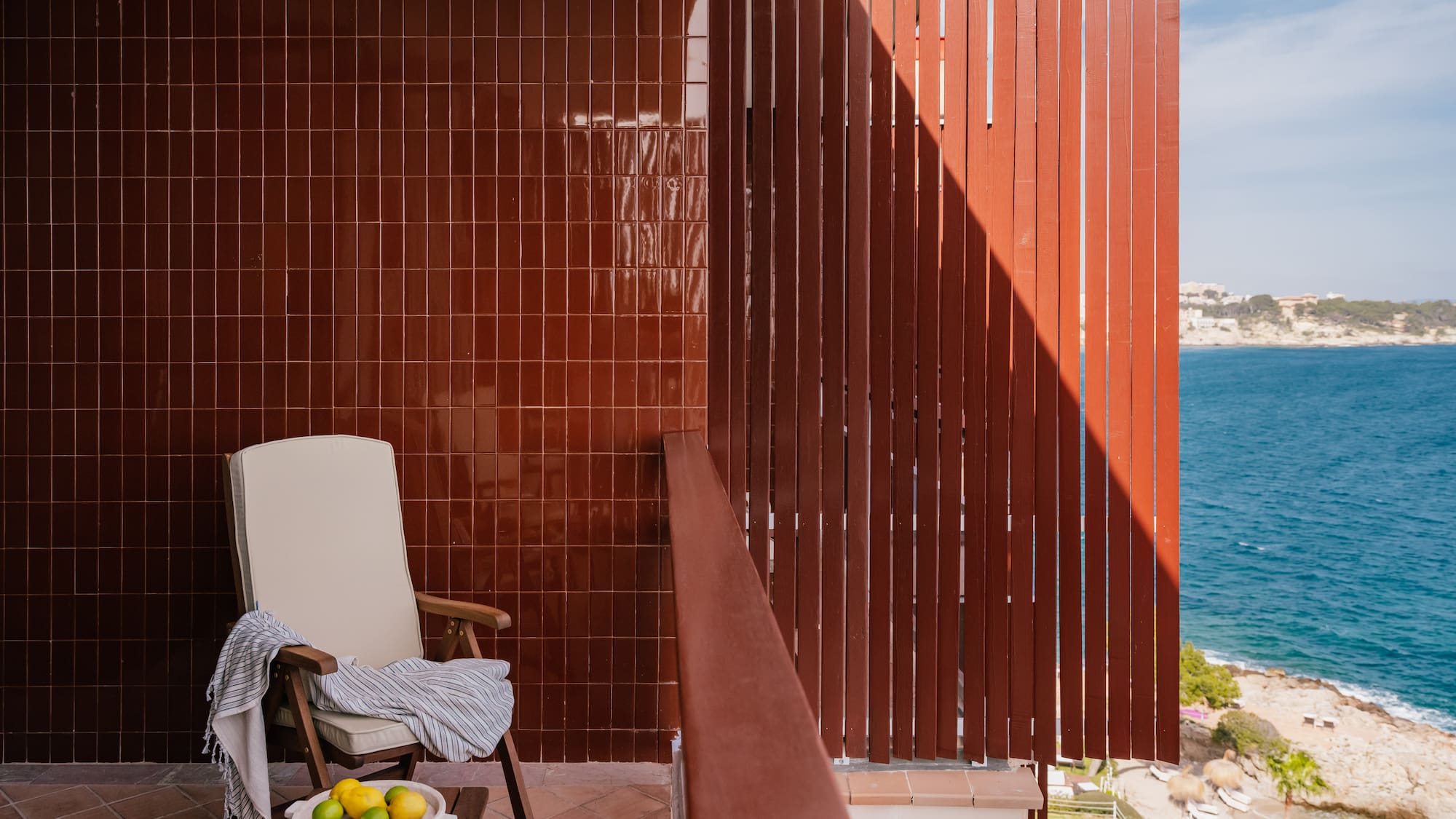 a chair on a balcony overlooking water