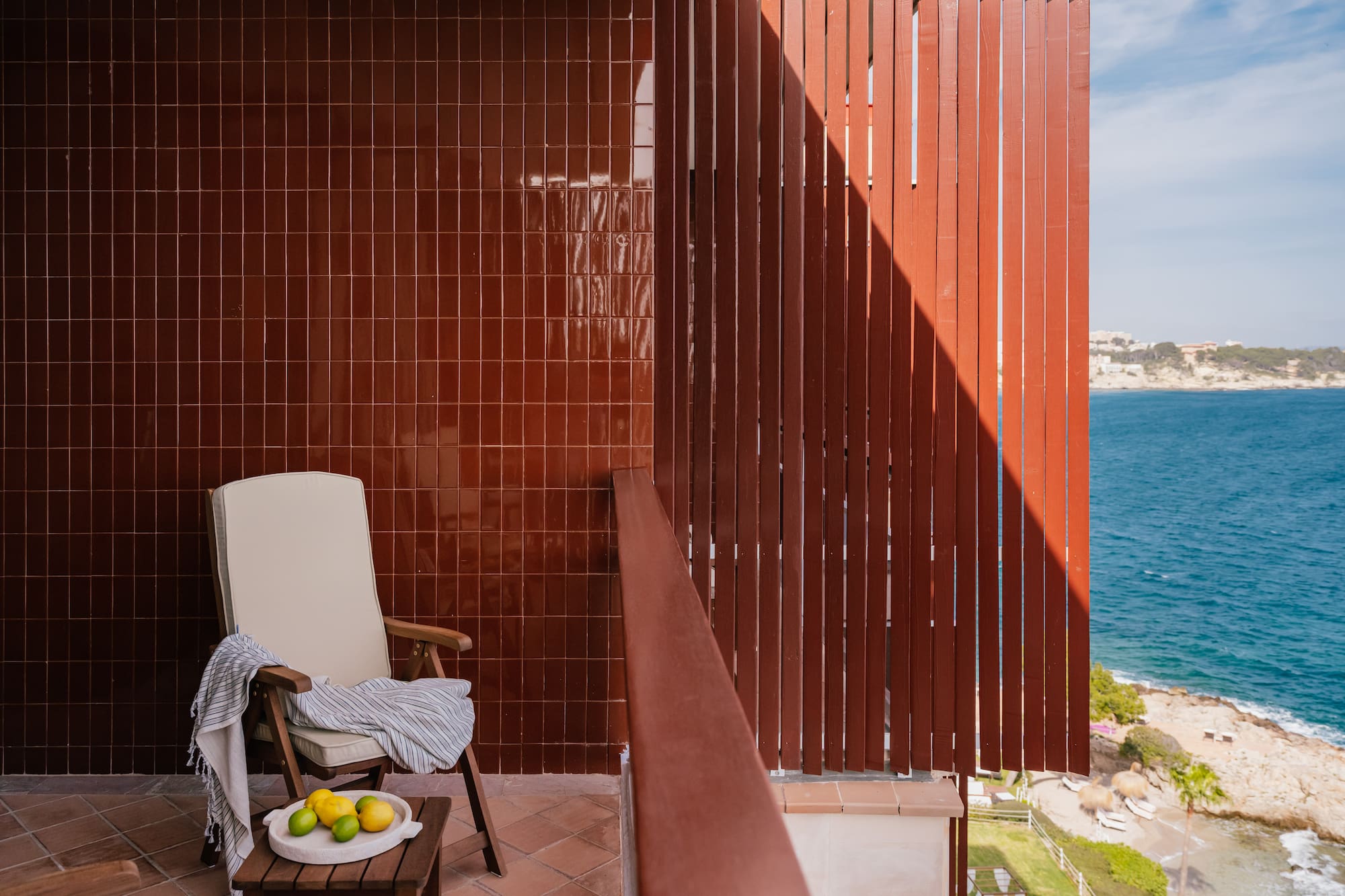 a chair on a balcony overlooking water