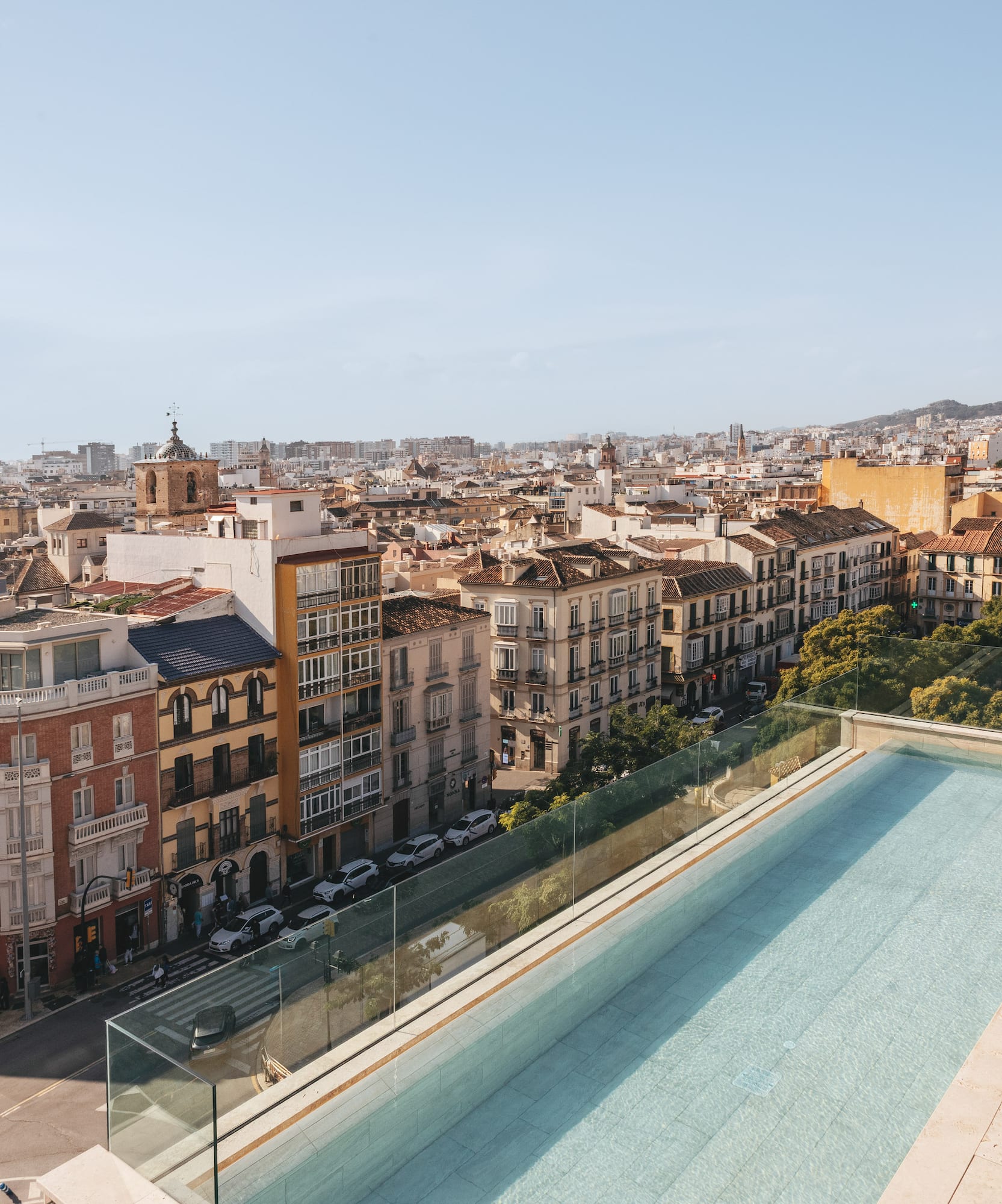 a pool on a rooftop overlooking a city