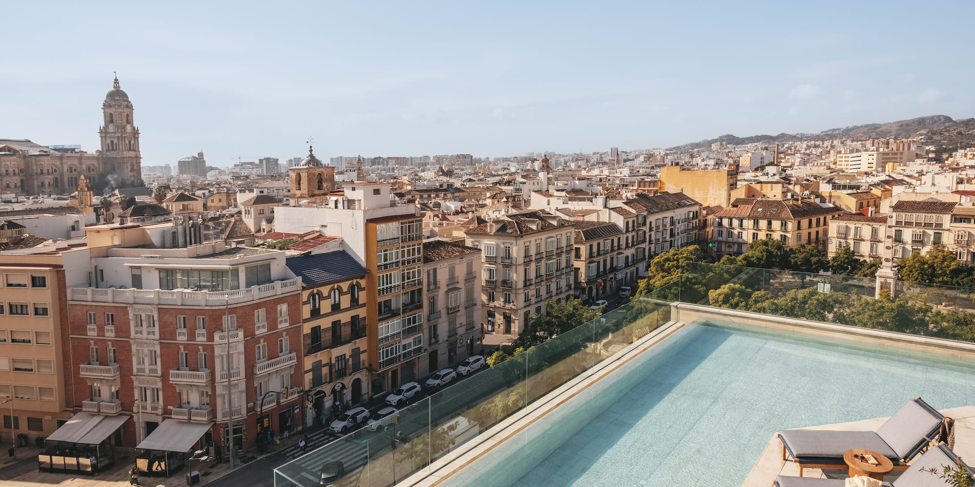 a pool on a rooftop overlooking a city