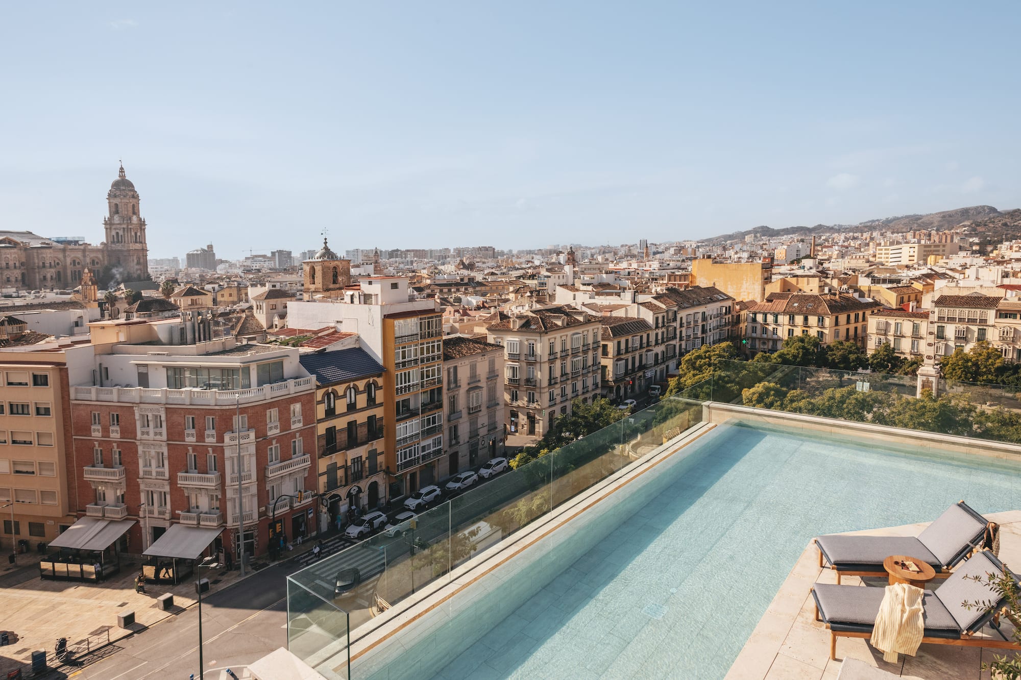 a pool on a rooftop overlooking a city