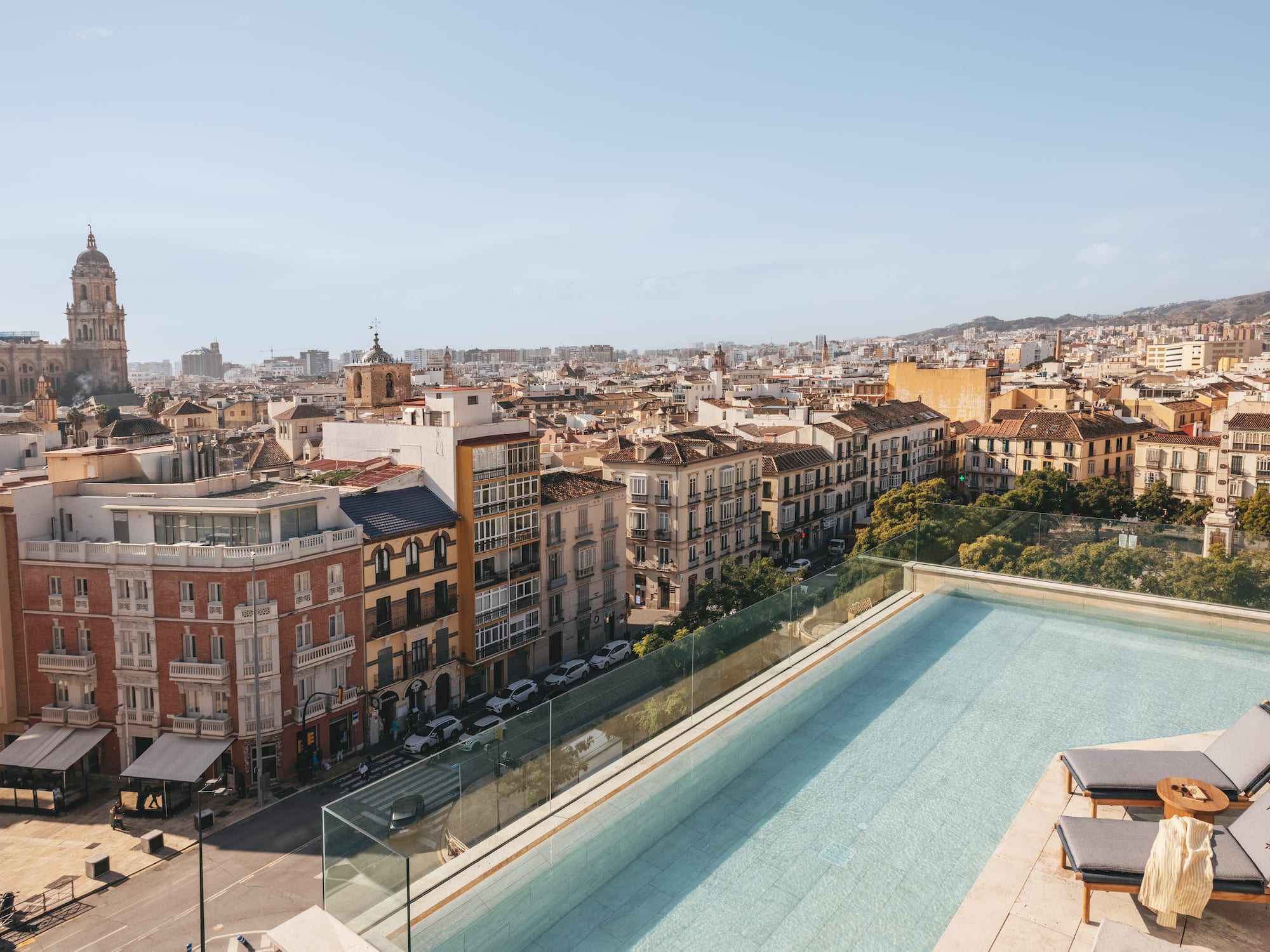a pool on a rooftop overlooking a city