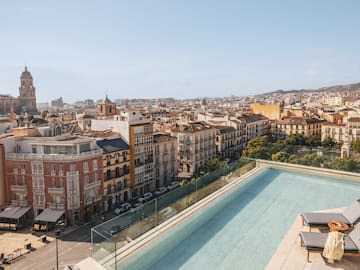 a pool on a rooftop overlooking a city