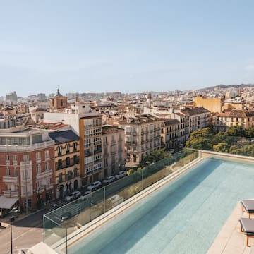 a pool on a rooftop overlooking a city