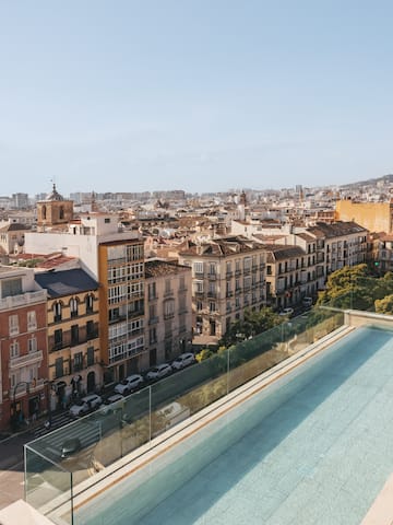 a pool on a rooftop overlooking a city