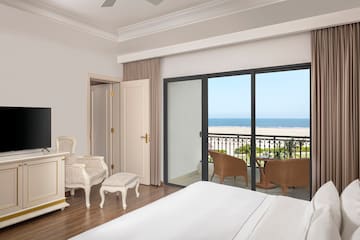 a bedroom with a balcony overlooking the ocean