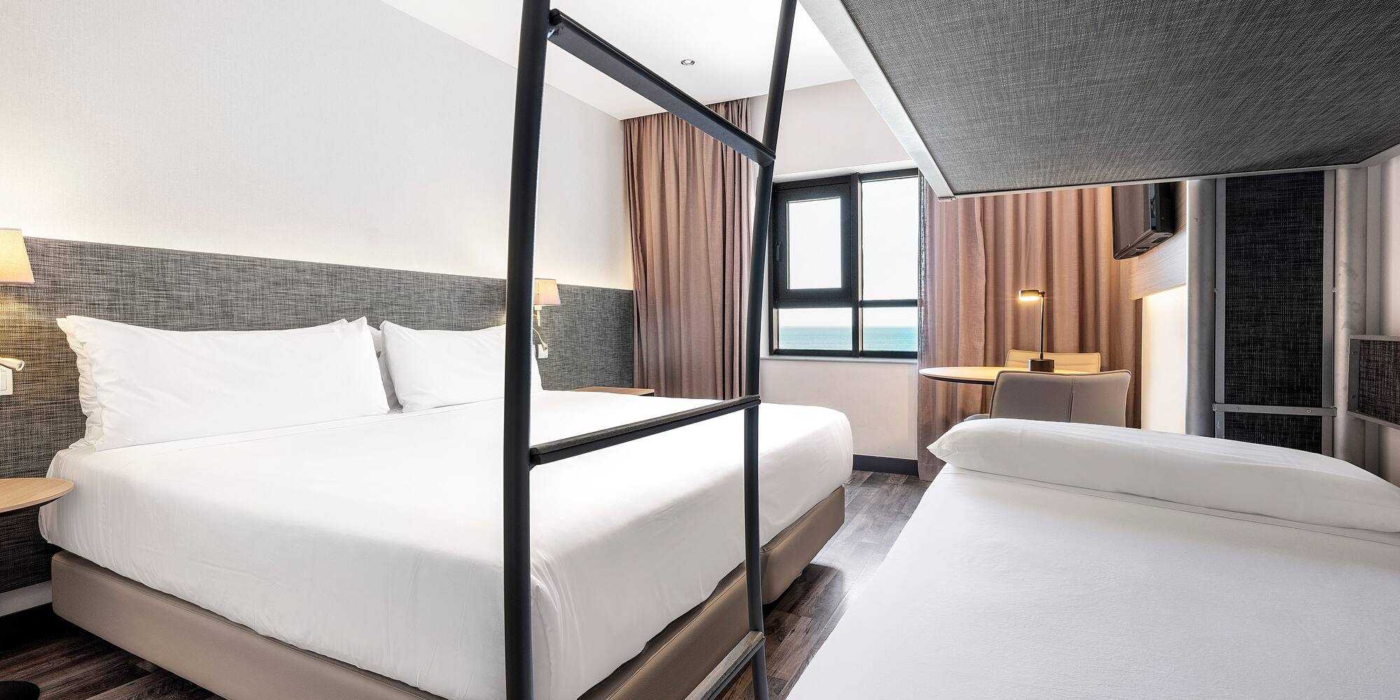 a room with two beds and a window