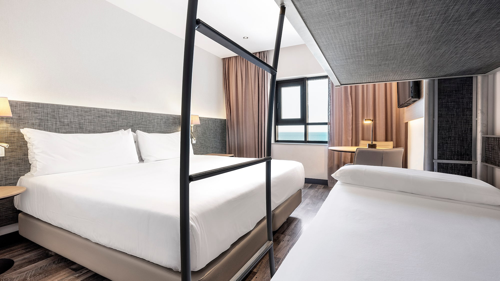 a room with two beds and a window