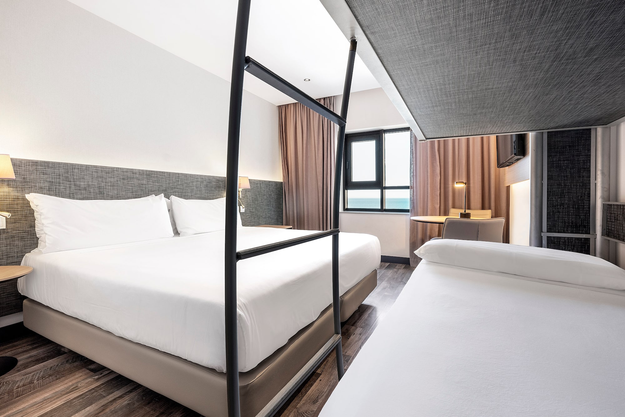 a room with two beds and a window