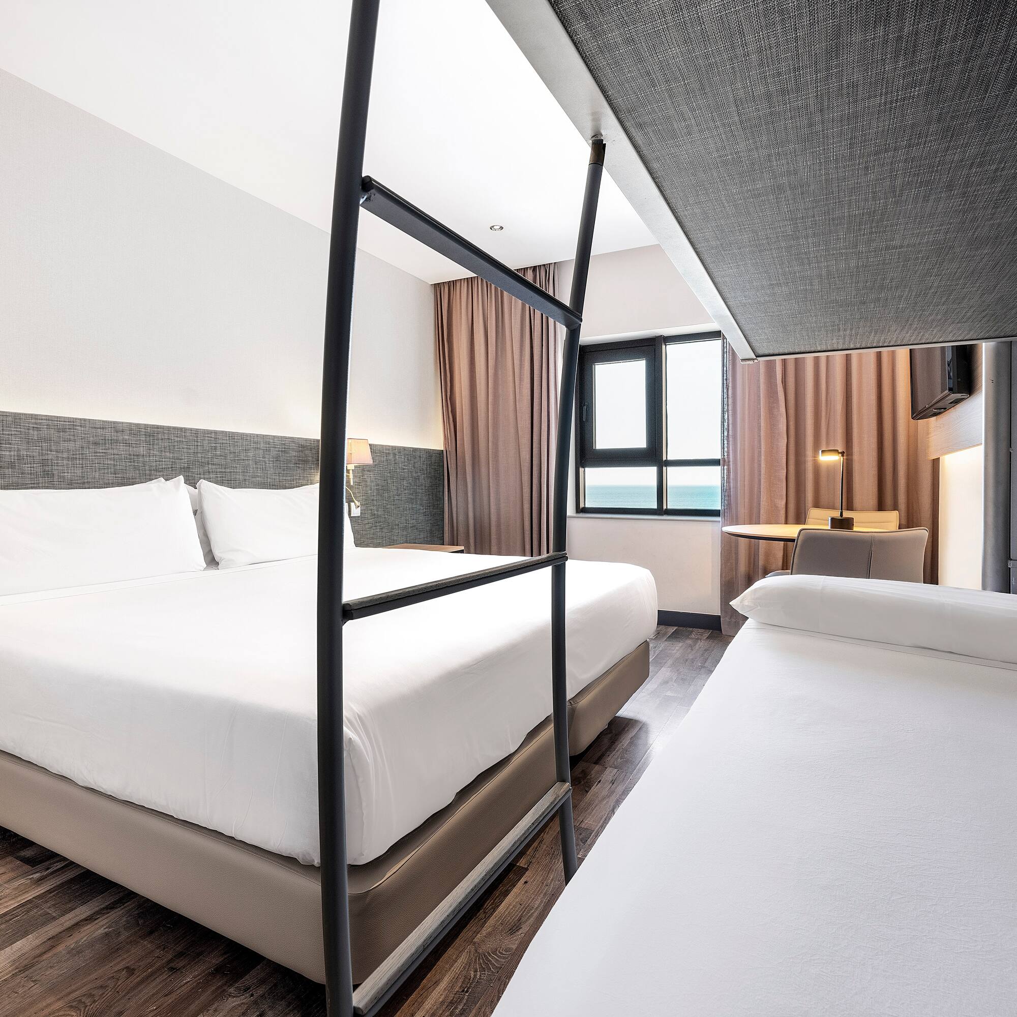 a room with two beds and a window