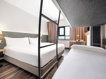 a room with two beds and a window