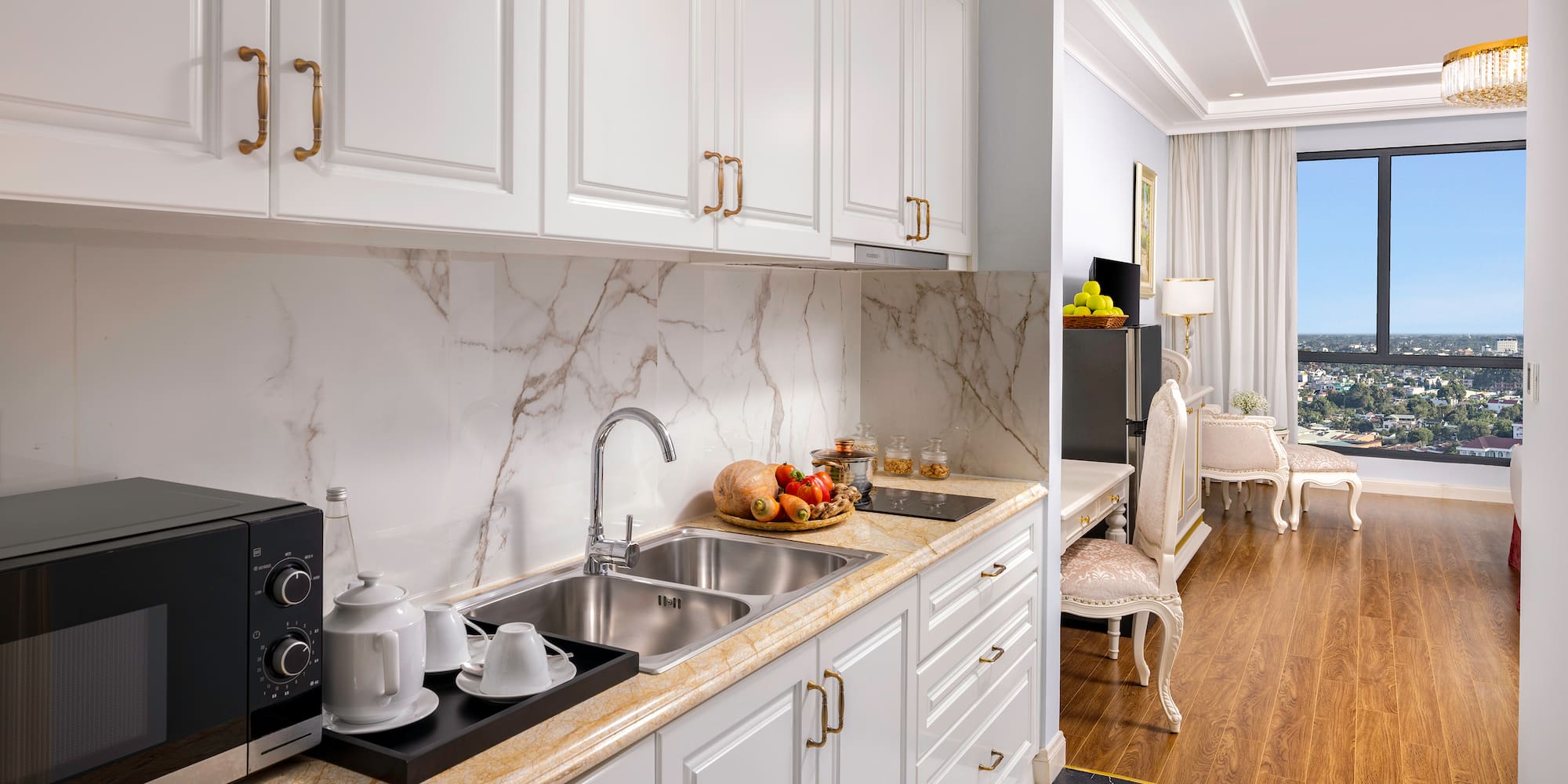 a kitchen with white cabinets and a marble countertop