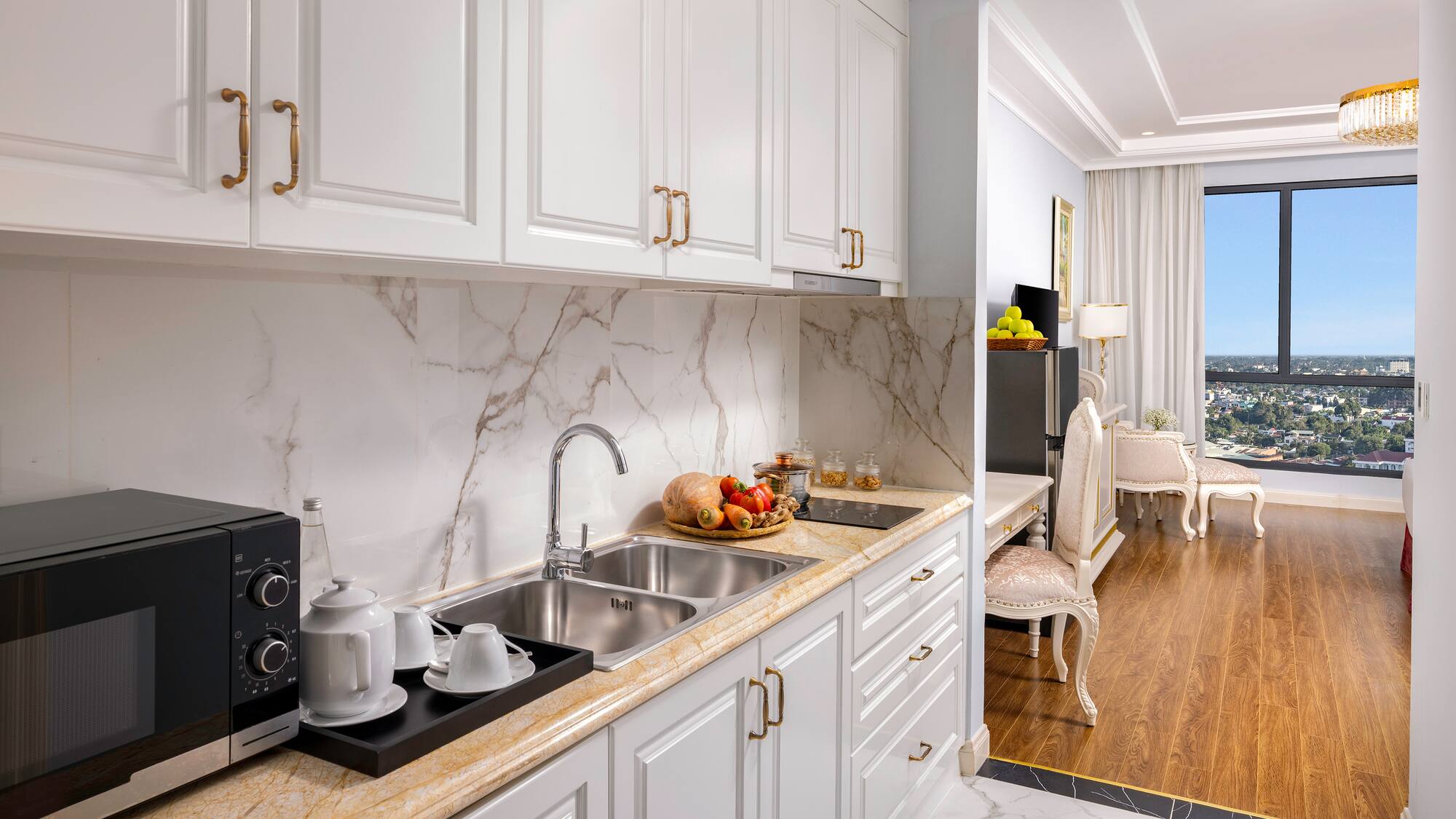 a kitchen with white cabinets and a marble countertop