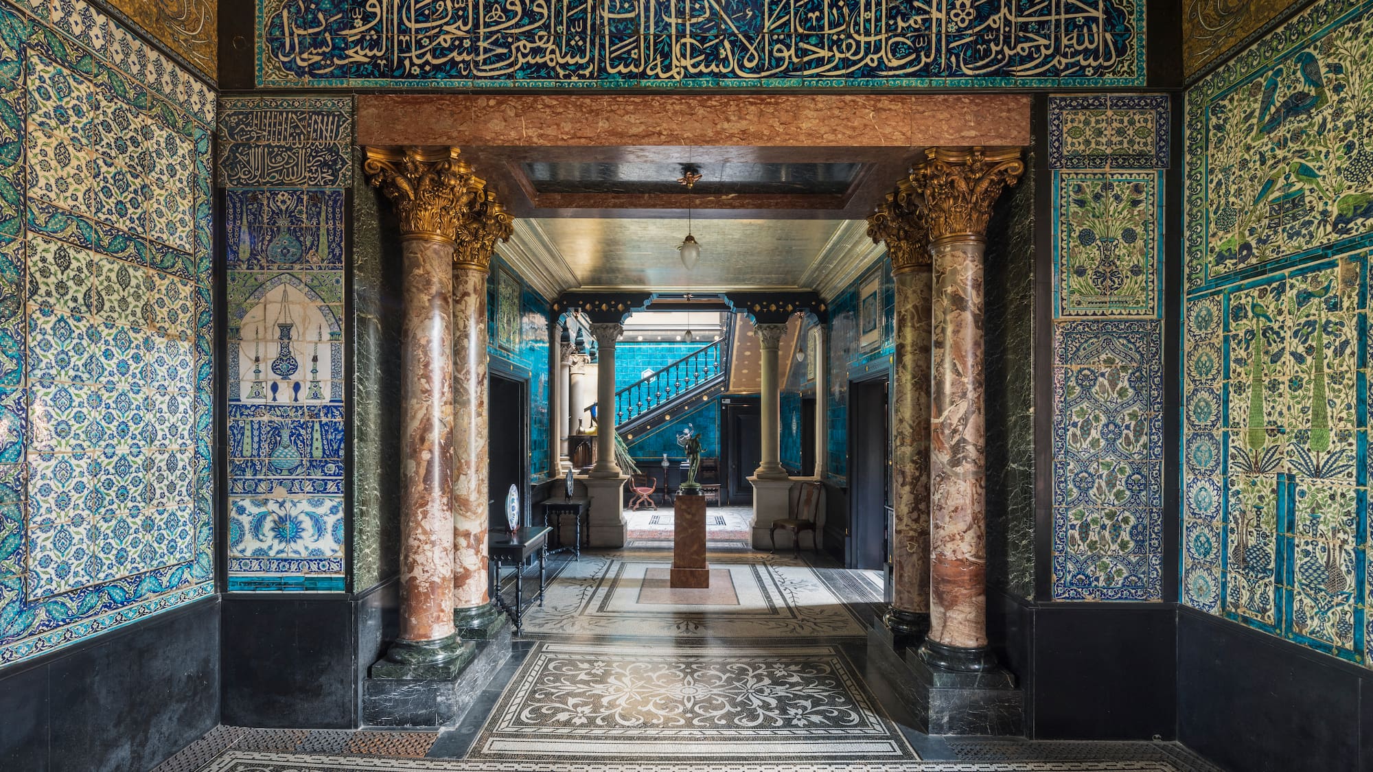a hallway with ornate walls and a carpet