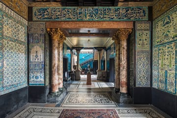 a hallway with ornate walls and a carpet