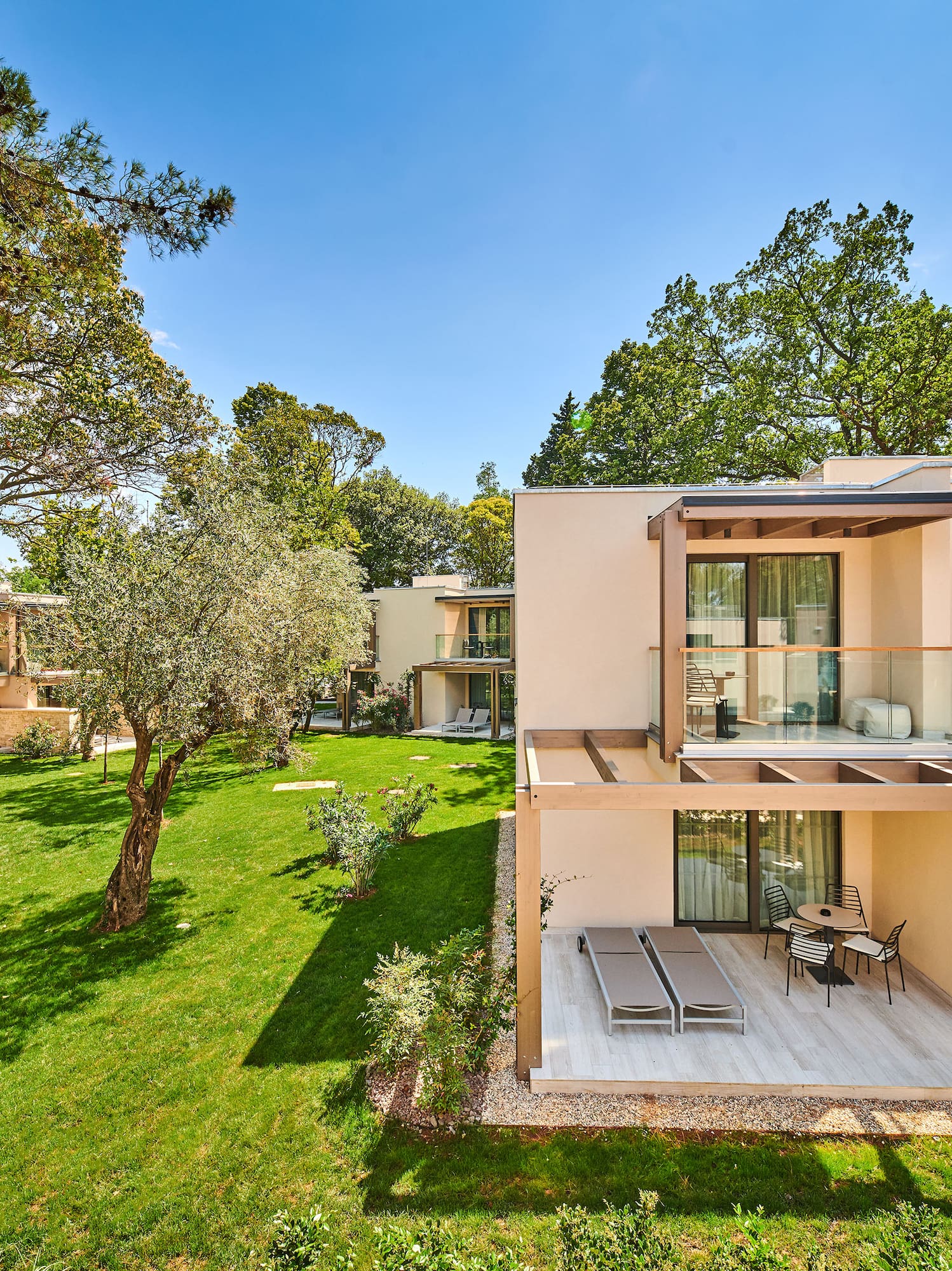 a building with a deck and a lawn