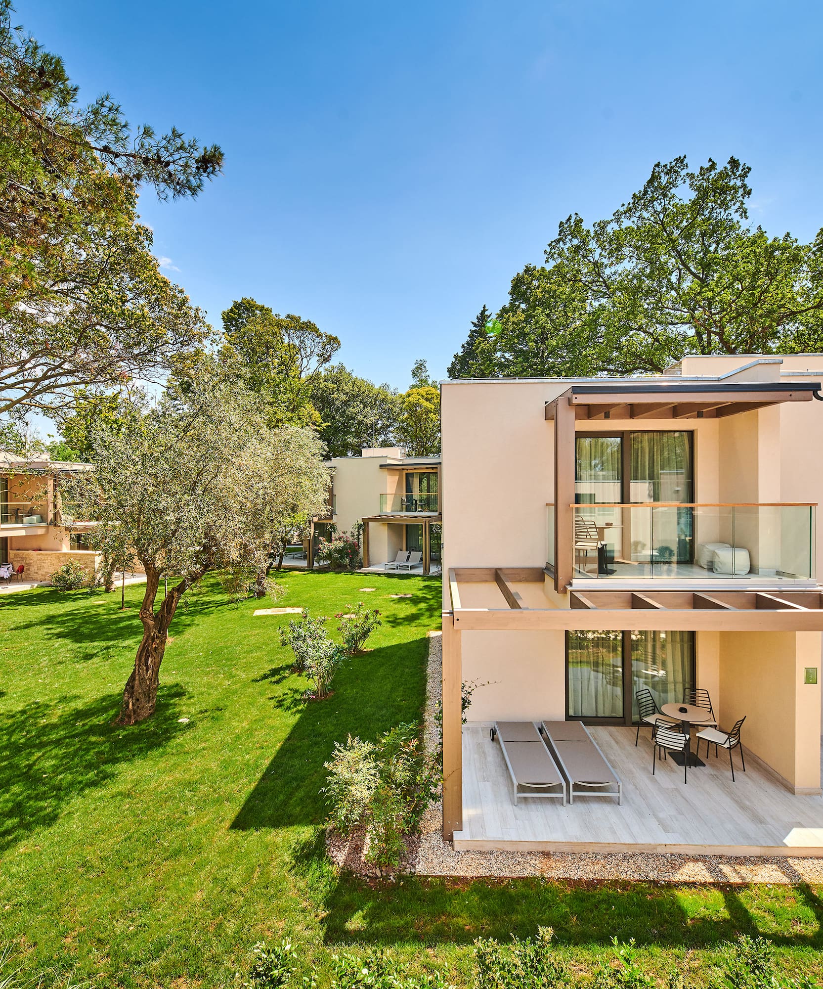 a building with a deck and a lawn