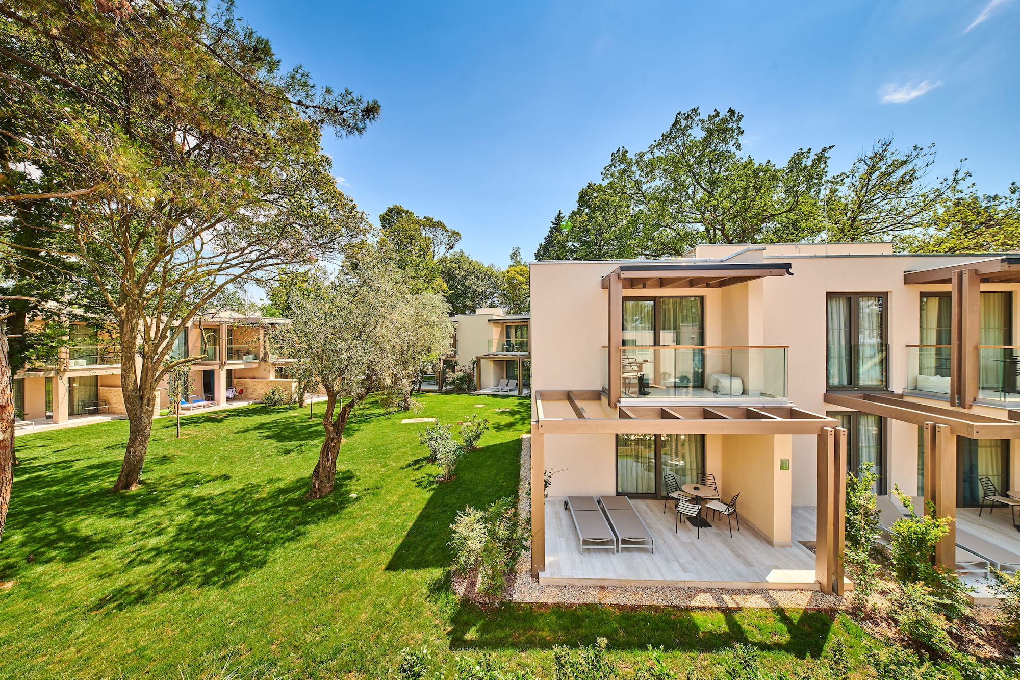 a building with a deck and a lawn