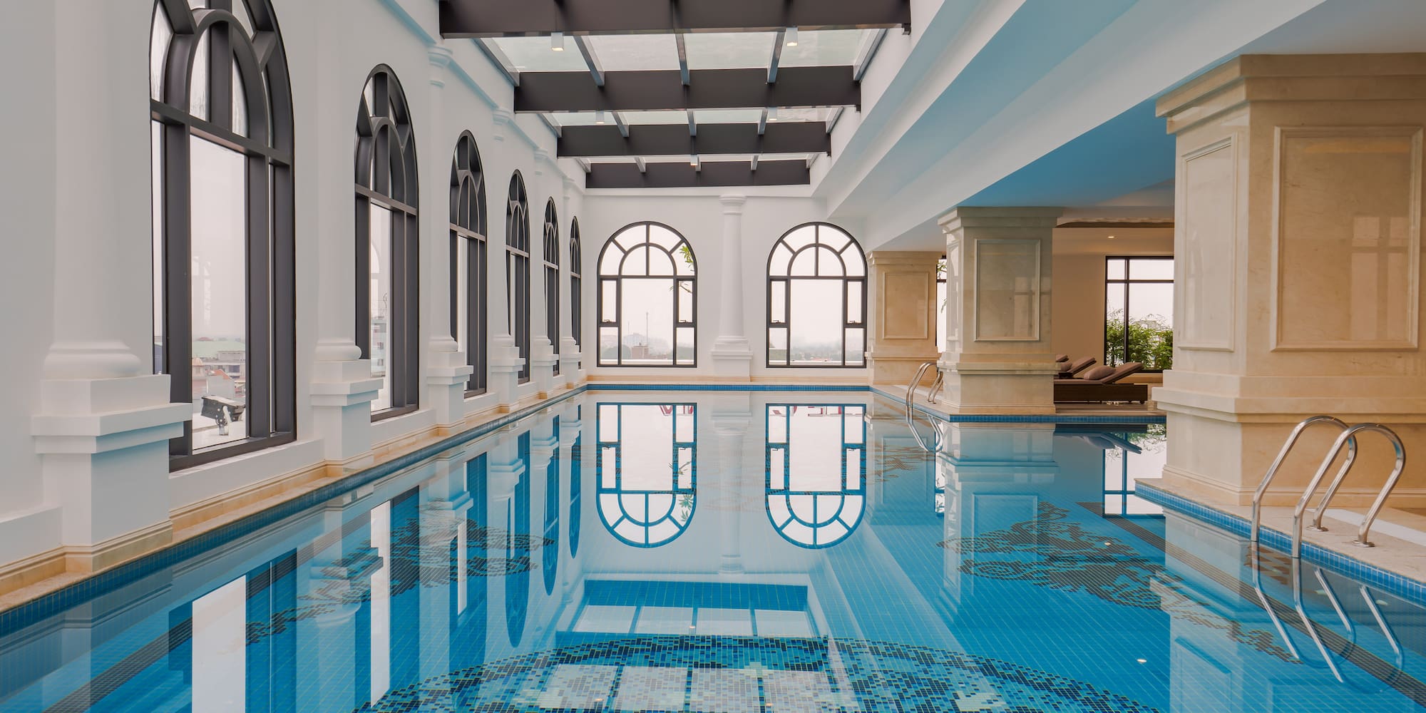 a indoor swimming pool with arched windows