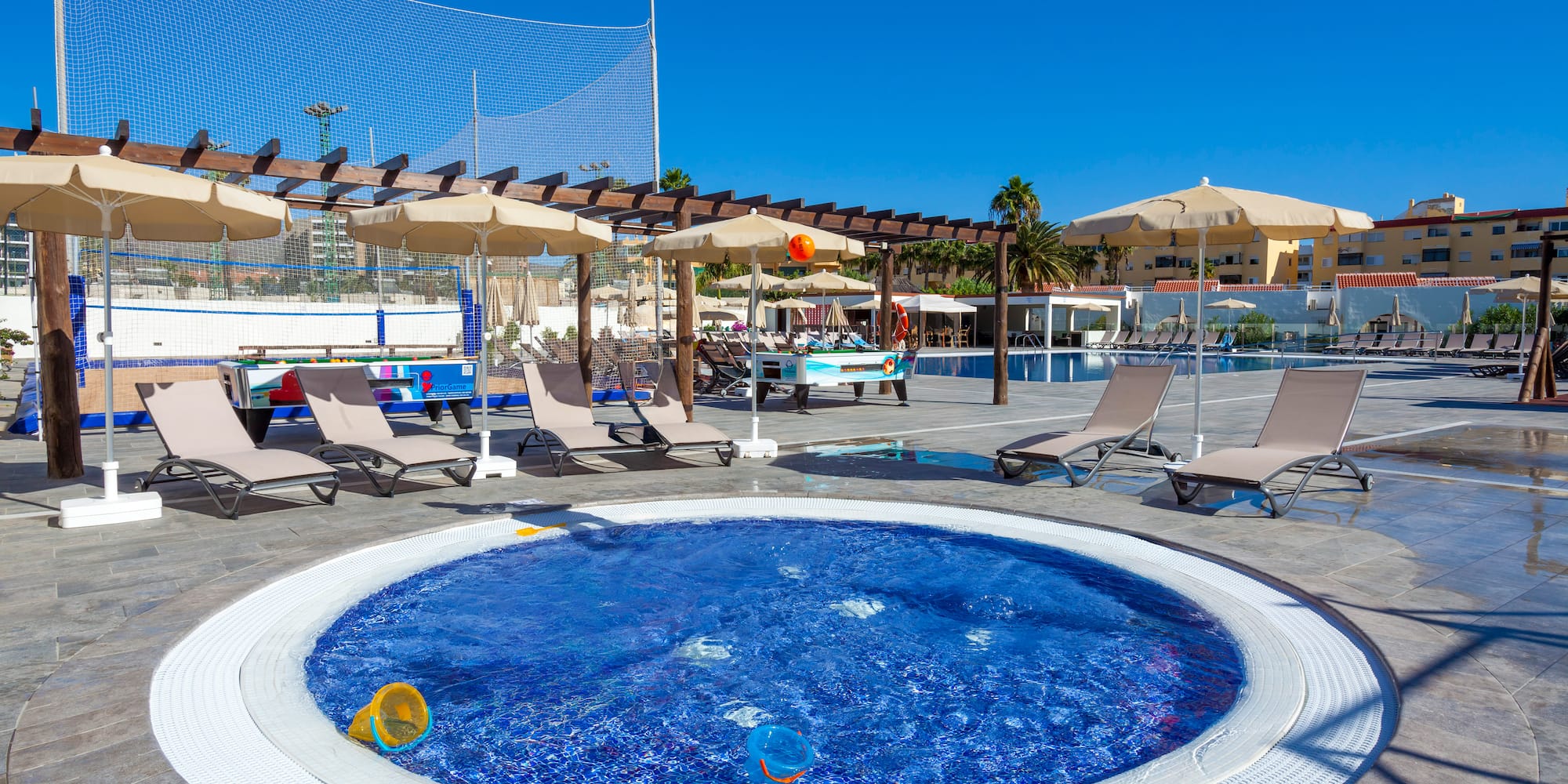 a pool with chairs and umbrellas