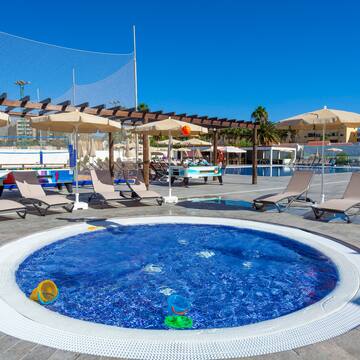 a pool with chairs and umbrellas