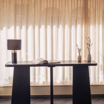 a table with a lamp and vases on it