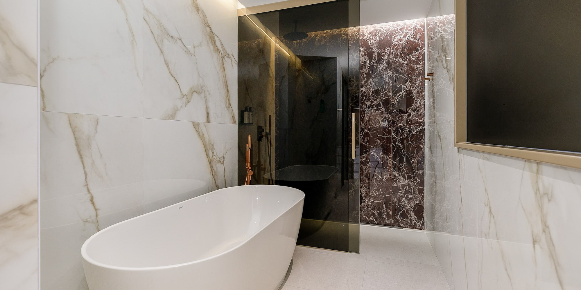 a bathroom with a tub and shower