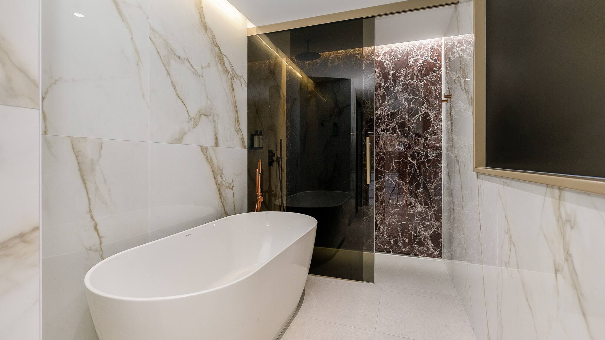 a bathroom with a tub and shower