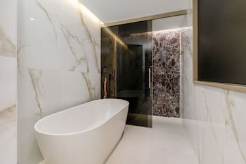 a bathroom with a tub and shower