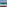 Modern balcony ocean view with glass railing, turquoise beach water.
