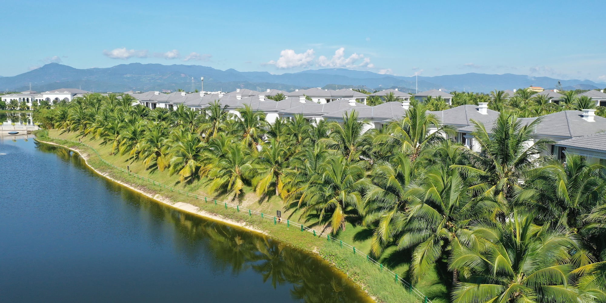 a body of water with houses and trees