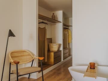 a room with a tub and a chair