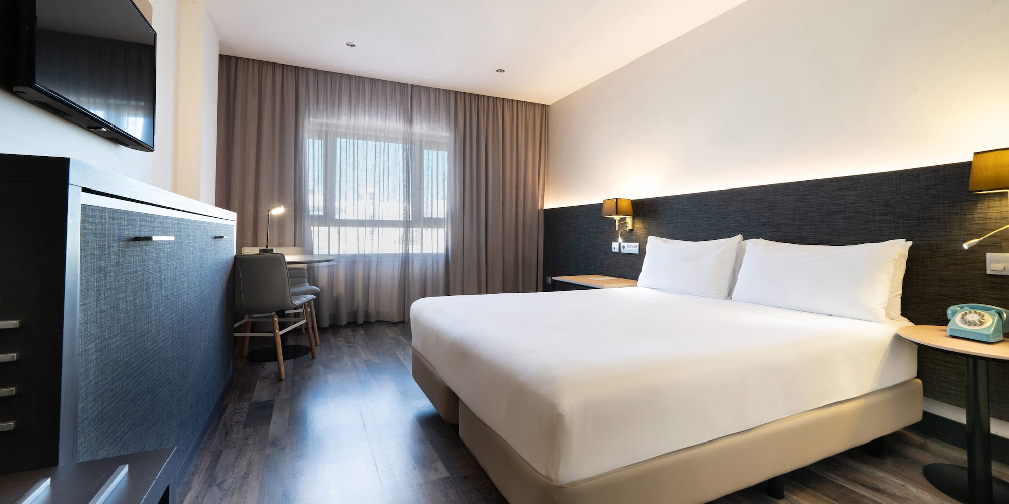 a room with a bed and a desk