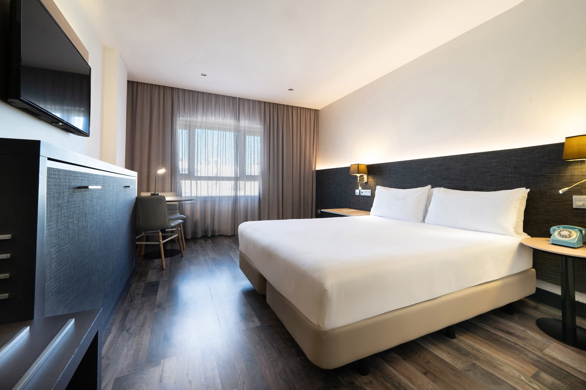 a room with a bed and a desk