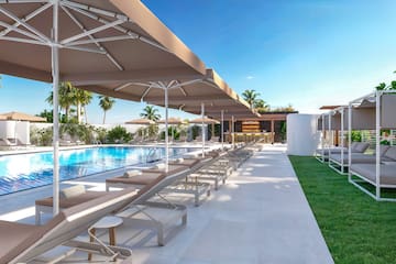 a pool with lounge chairs and umbrellas