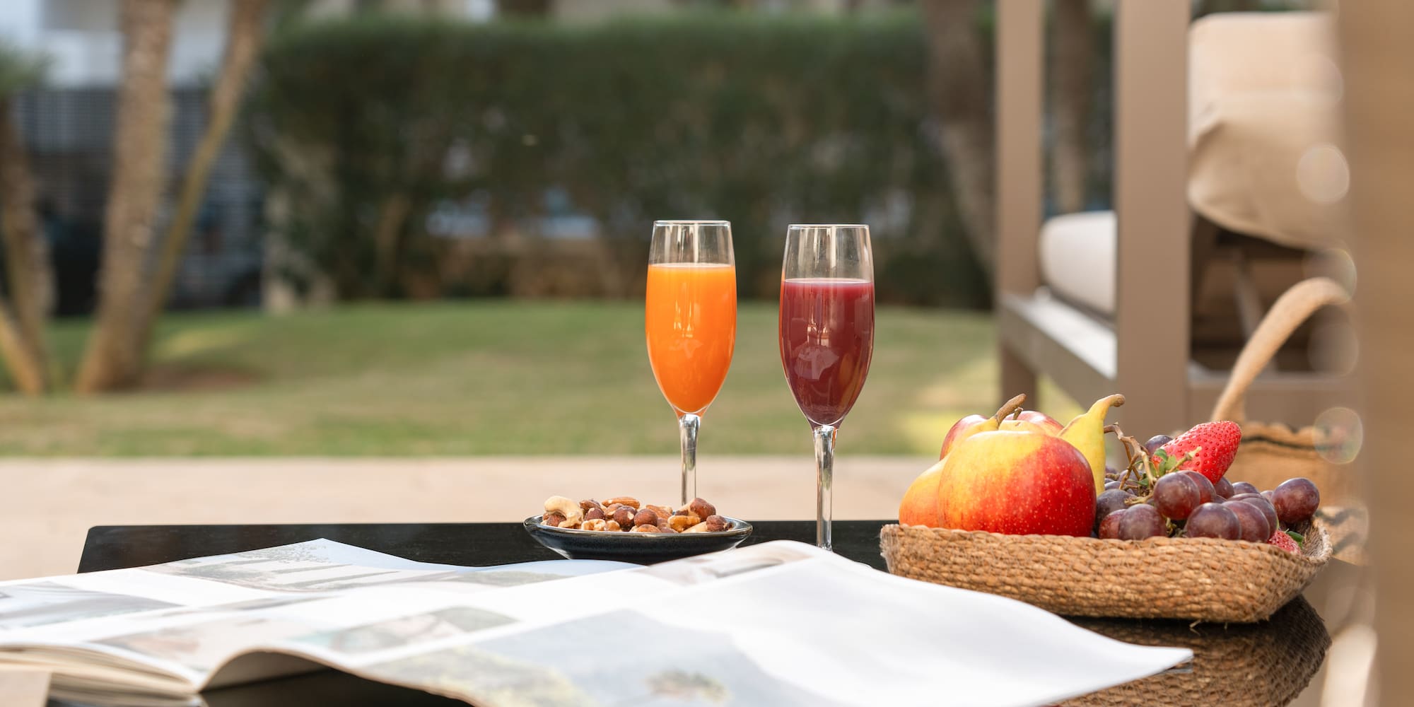 a fruit and a bowl of nuts on a table