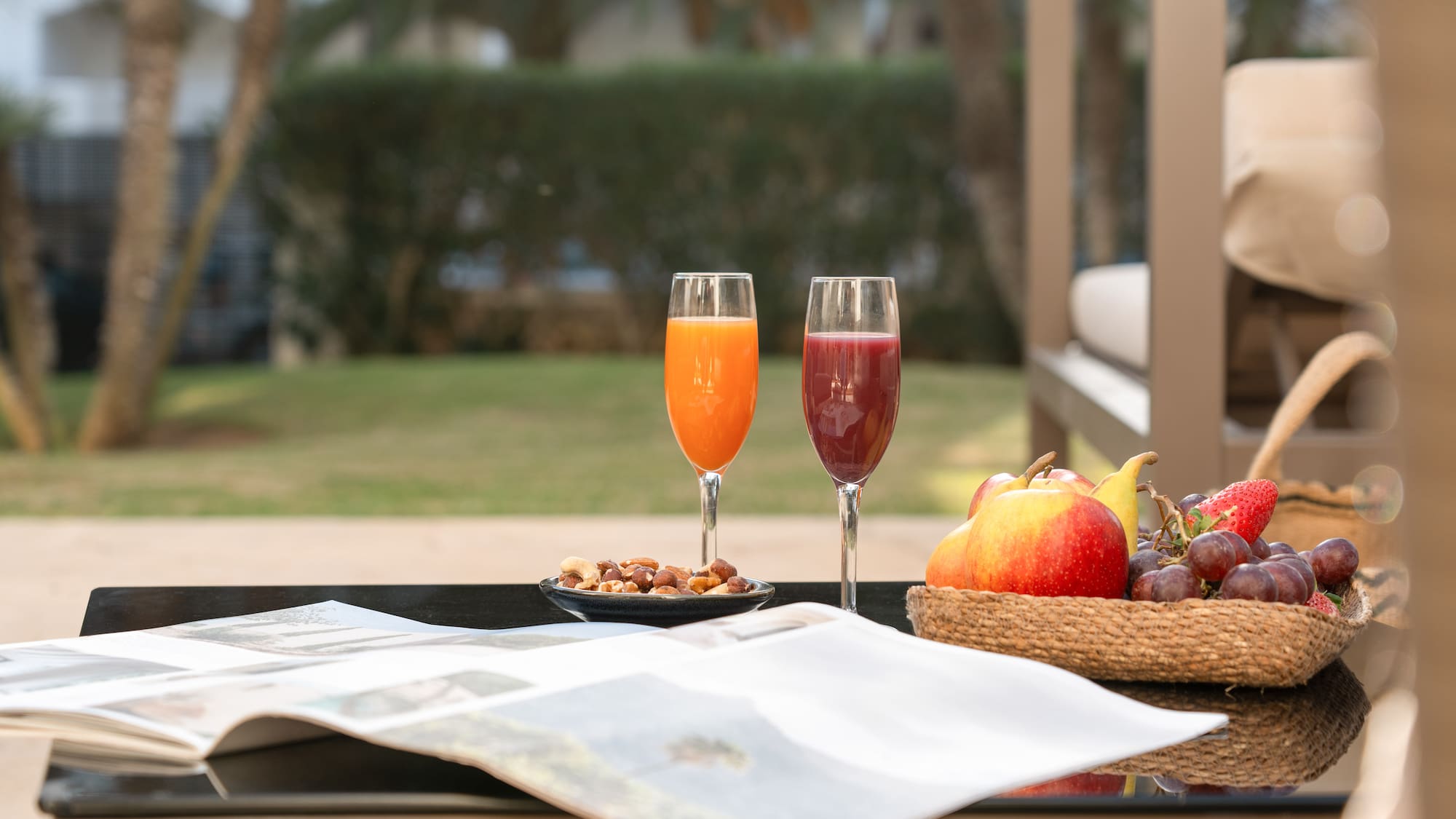 a fruit and a bowl of nuts on a table