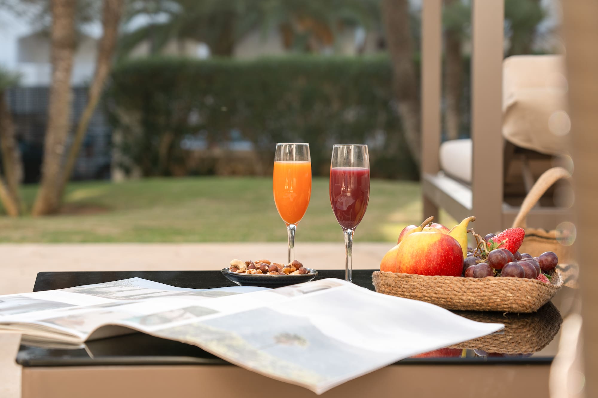 a fruit and a bowl of nuts on a table