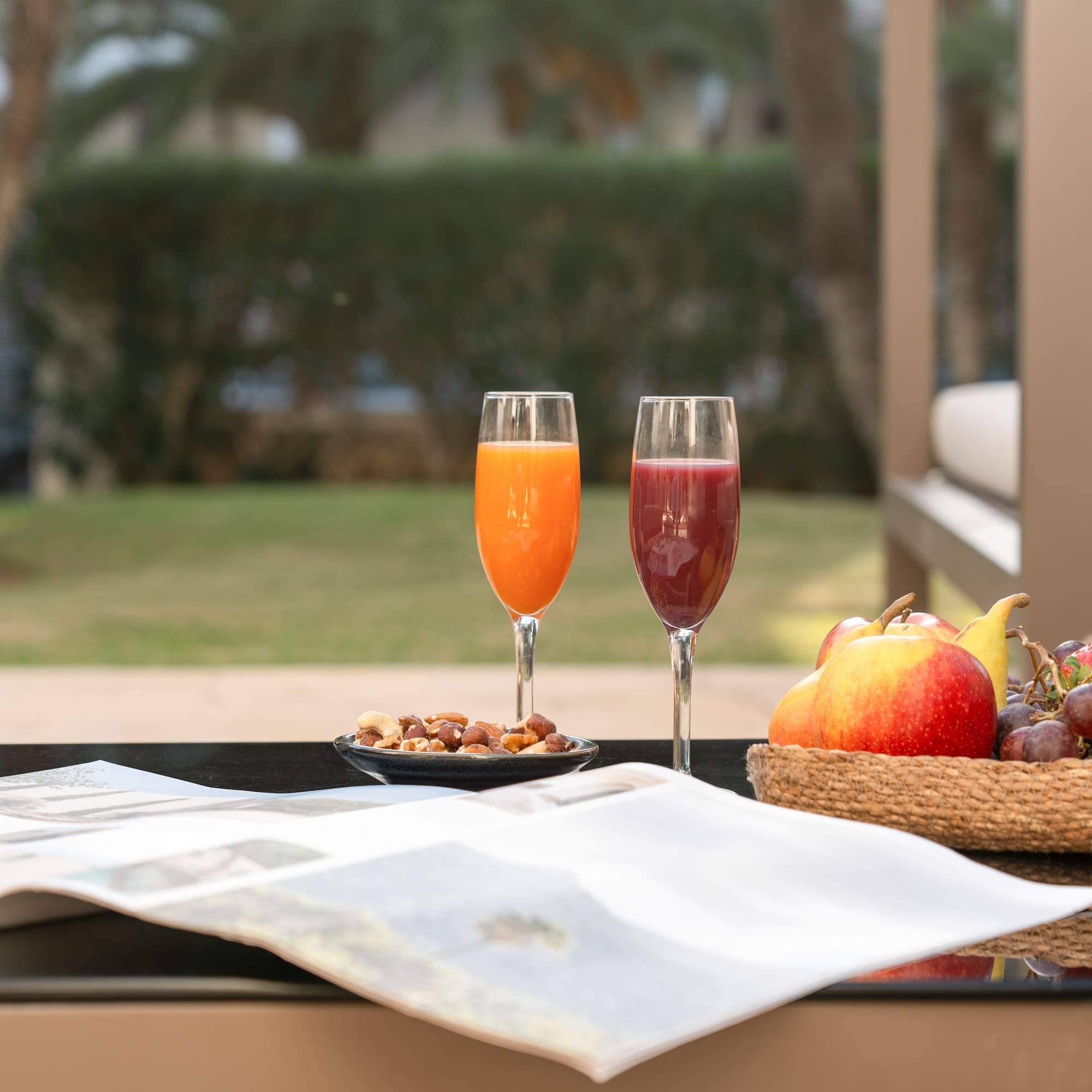 a fruit and a bowl of nuts on a table