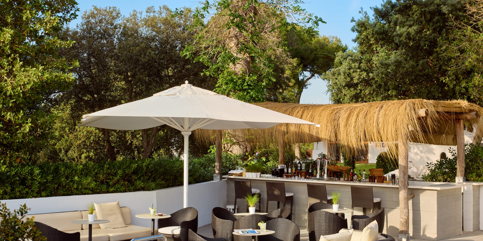 a patio with chairs and umbrellas