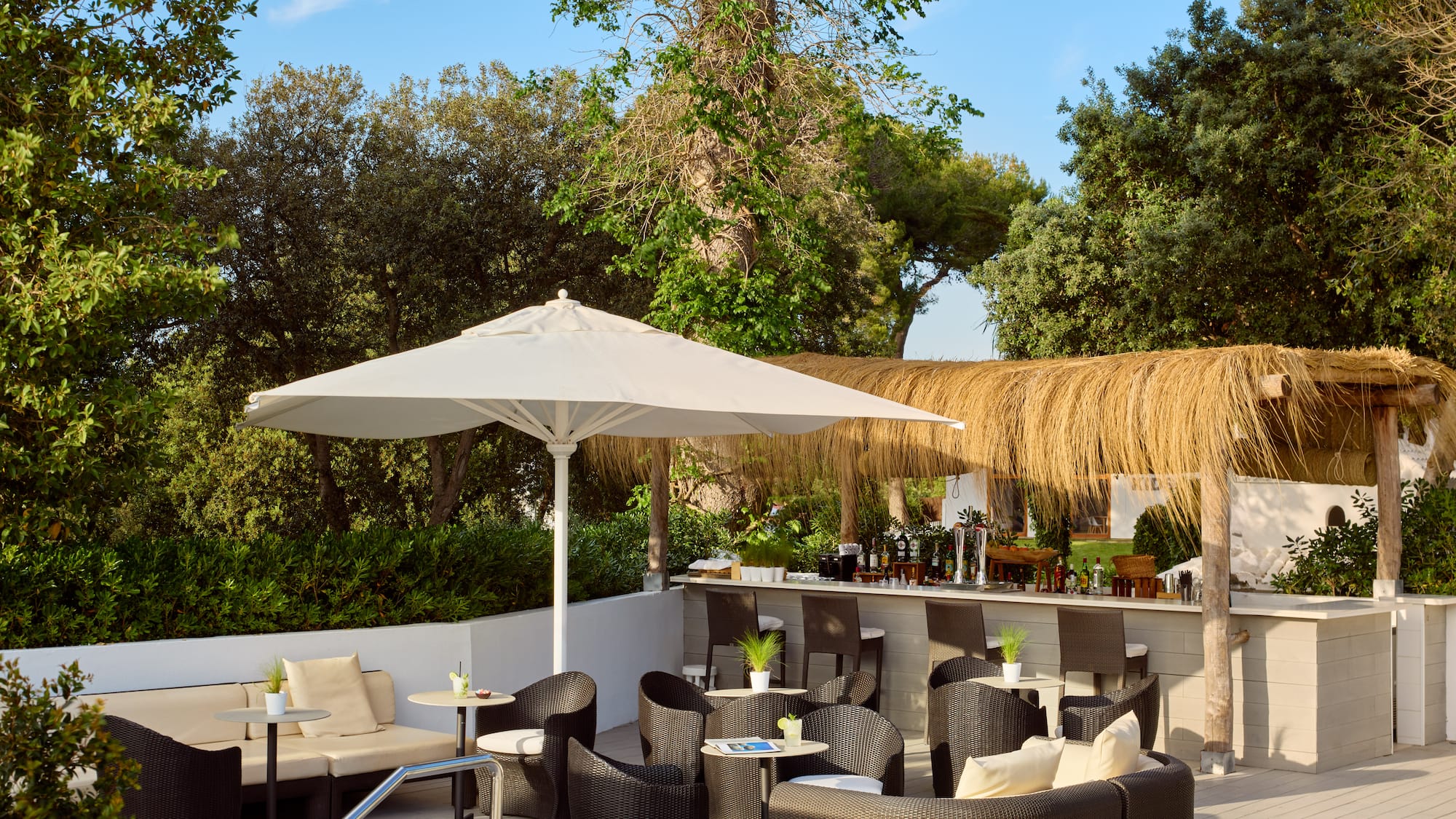 a patio with chairs and umbrellas