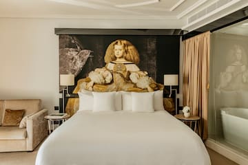a bed with a large picture of a woman