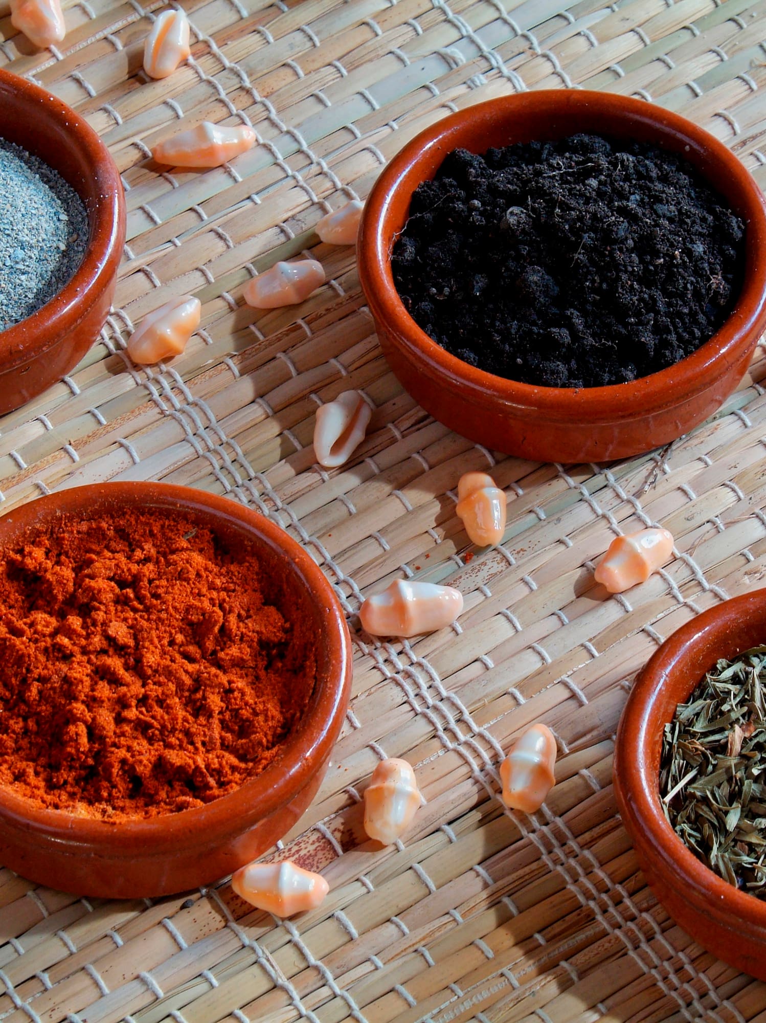 a group of small bowls of spices