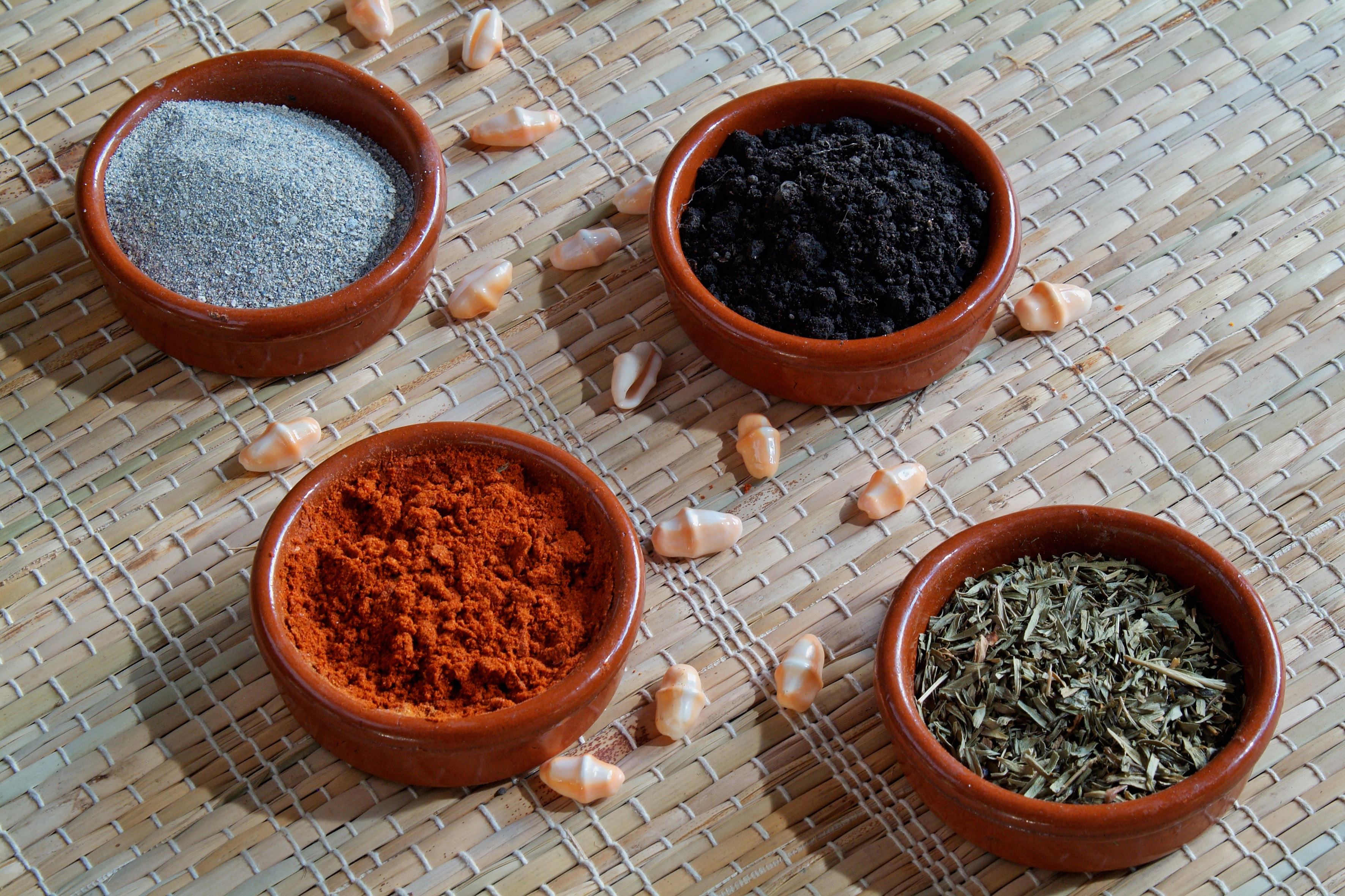 a group of small bowls of spices