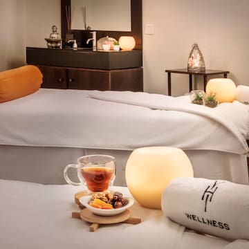 a massage table with towels and a cup of tea