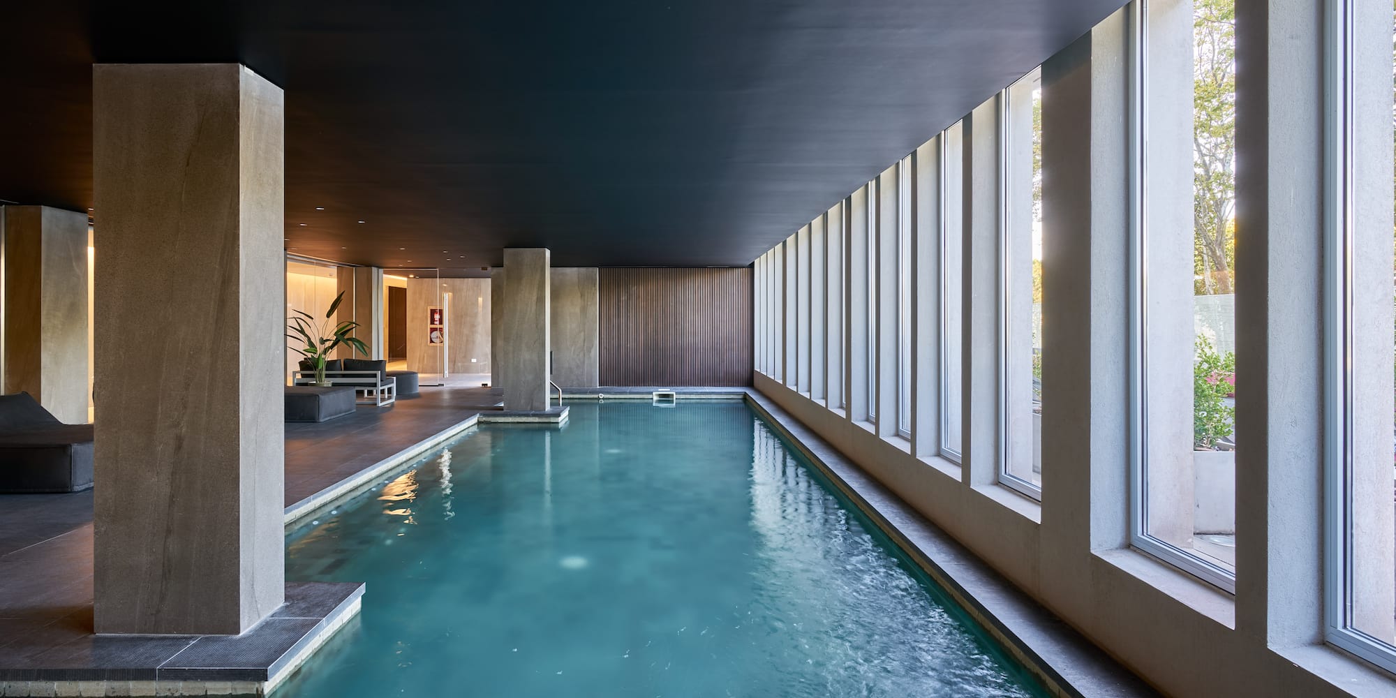 a indoor pool with large windows