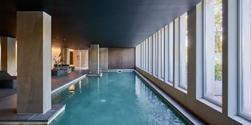 a indoor pool with large windows